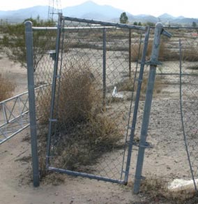 Gate held closed by weeds